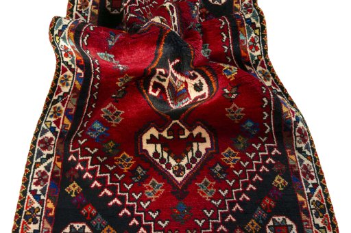 Corner detail of 2000s Shiraz rug showing border pattern and Wool pile
