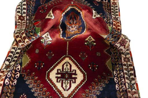 Corner detail of 2000s Shiraz rug showing border pattern and Wool pile