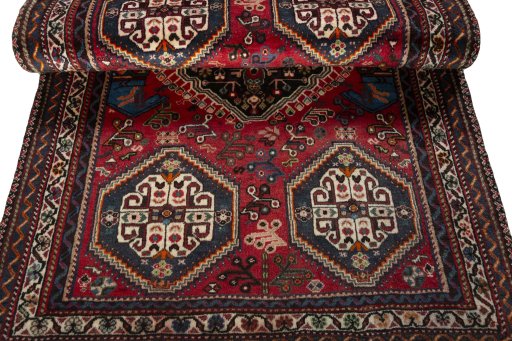 Corner detail of 2000s Shiraz rug showing border pattern and Wool pile