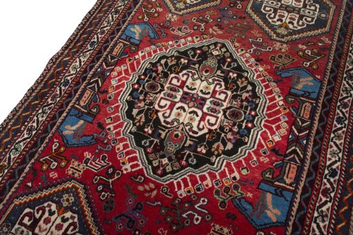 Backside of handmade 2000s Shiraz rug showing knot structure and weave density