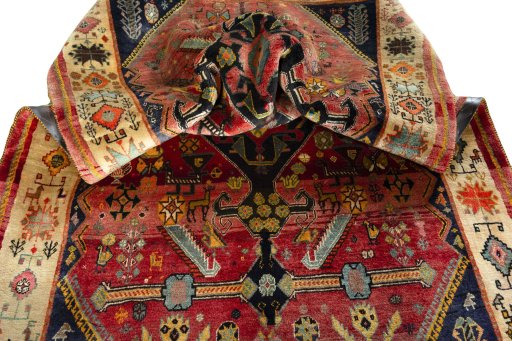 Corner detail of 2000s Shiraz rug showing border pattern and Wool pile