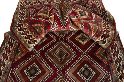 Corner detail of 2000s Shiraz rug showing border pattern and Wool pile