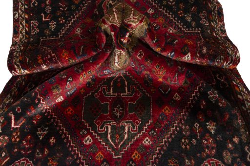 Corner detail of 2000s Shiraz rug showing border pattern and Wool pile