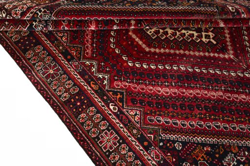 Corner detail of 2000s Shiraz rug showing border pattern and Wool pile