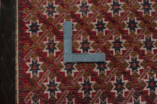 Backside of handmade 2000s Shiraz rug showing knot structure and weave density