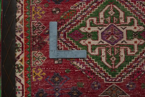 Backside of handmade 2000s Shiraz rug showing knot structure and weave density