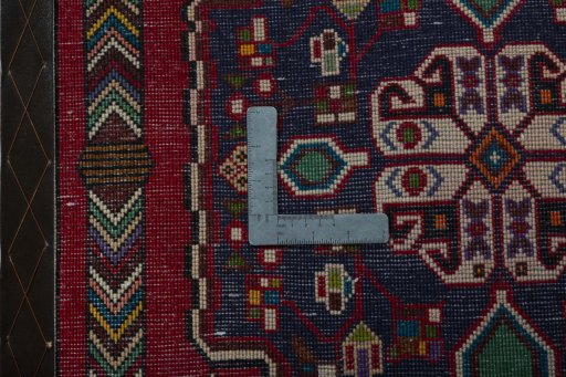 Backside of handmade 2000s Shiraz rug showing knot structure and weave density