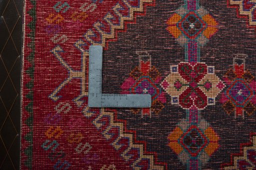 Backside of handmade 2000s Shiraz rug showing knot structure and weave density