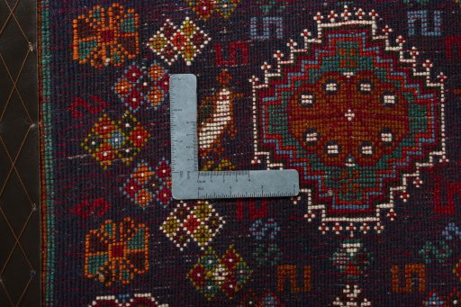 Backside of handmade 2000s Shiraz rug showing knot structure and weave density