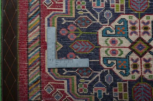 Backside of handmade 2000s Shiraz rug showing knot structure and weave density