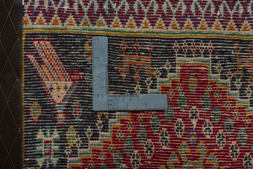 Backside of handmade 2000s Shiraz rug showing knot structure and weave density