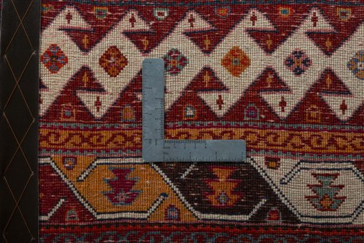 Backside of handmade 2000s Shiraz rug showing knot structure and weave density