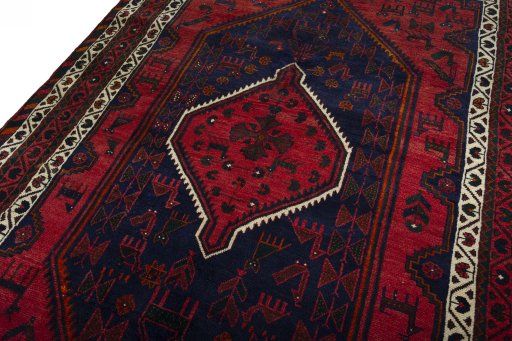 Backside of handmade 2000s Shiraz rug showing knot structure and weave density