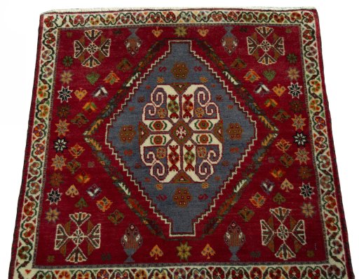 Surface texture of 2000s Shiraz rug with natural Wool and intricate pattern