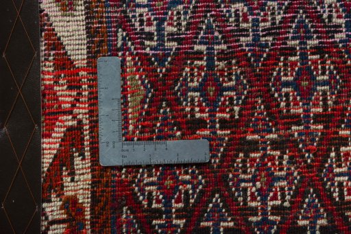 Backside of handmade 2000s Shiraz rug showing knot structure and weave density