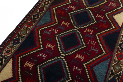Backside of handmade 2000s Shiraz rug showing knot structure and weave density