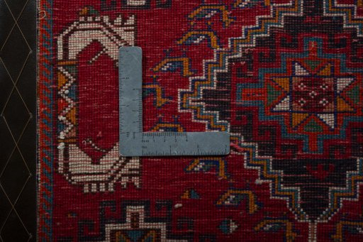 Backside of handmade 2000s Shiraz rug showing knot structure and weave density
