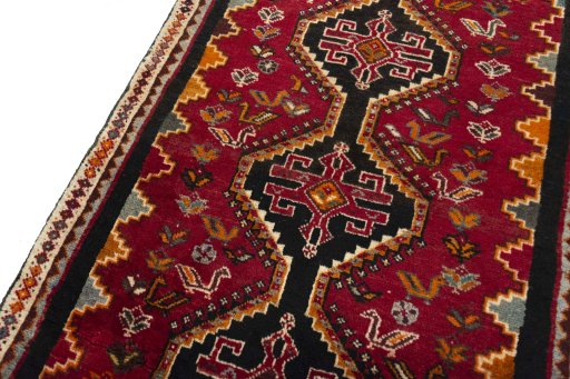 Backside of handmade 2000s Shiraz rug showing knot structure and weave density