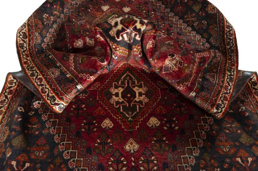 Corner detail of 2000s Shiraz rug showing border pattern and Wool pile