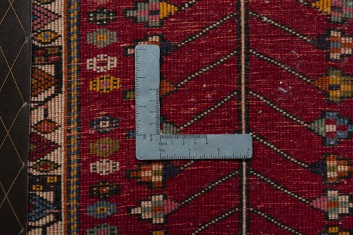 Backside of handmade 2000s Shiraz rug showing knot structure and weave density