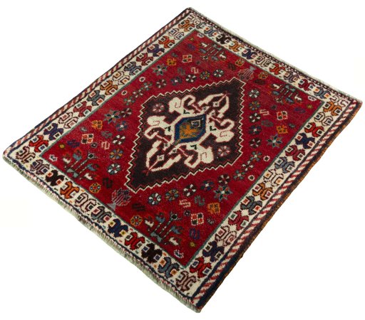 Corner detail of 2000s Shiraz rug showing border pattern and Wool pile