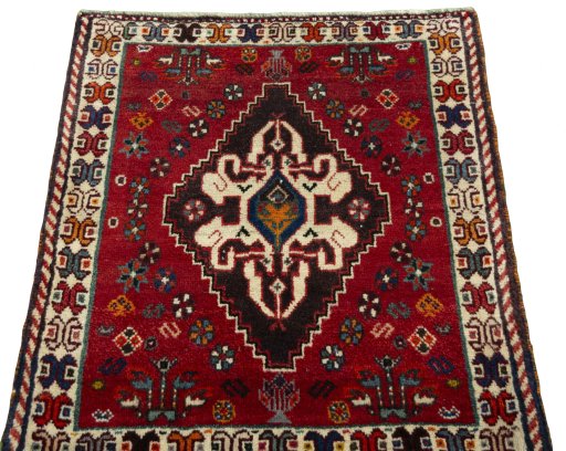 Surface texture of 2000s Shiraz rug with natural Wool and intricate pattern