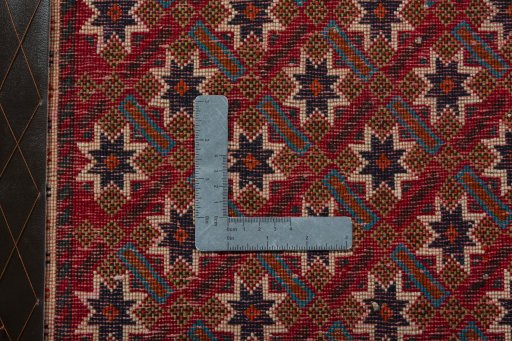 Backside of handmade 2000s Shiraz rug showing knot structure and weave density