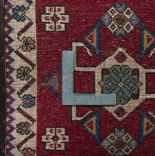 Backside of handmade 2000s Shiraz rug showing knot structure and weave density