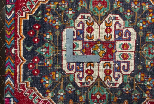Backside of handmade 2000s Shiraz rug showing knot structure and weave density