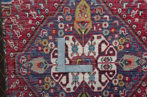 Backside of handmade 2000s Shiraz rug showing knot structure and weave density