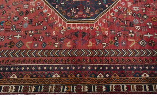 Corner detail of 2000s Shiraz rug showing border pattern and Wool pile