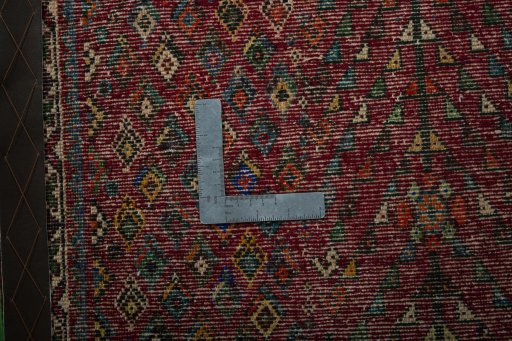 Backside of handmade 2000s Shiraz rug showing knot structure and weave density