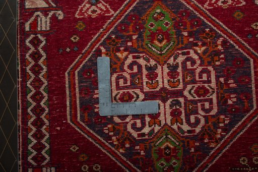Backside of handmade 2000s Shiraz rug showing knot structure and weave density