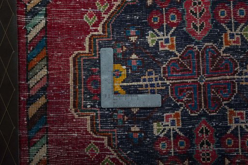 Backside of handmade 2000s Shiraz rug showing knot structure and weave density