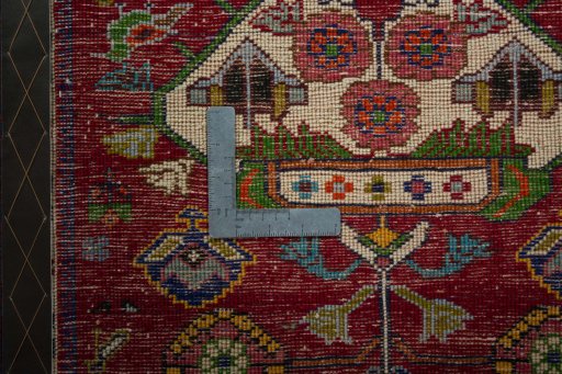 Backside of handmade 2000s Shiraz rug showing knot structure and weave density