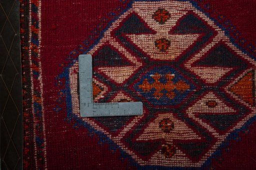 Backside of handmade 2000s Shiraz rug showing knot structure and weave density