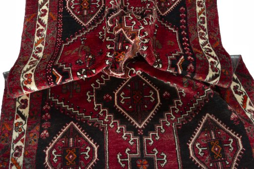 Corner detail of 2000s Shiraz rug showing border pattern and Wool pile