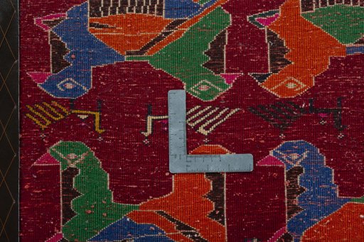 Backside of handmade 2000s Shiraz rug showing knot structure and weave density
