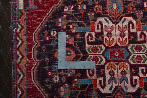 Backside of handmade 2000s Shiraz rug showing knot structure and weave density