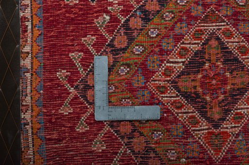 Backside of handmade 2000s Shiraz rug showing knot structure and weave density