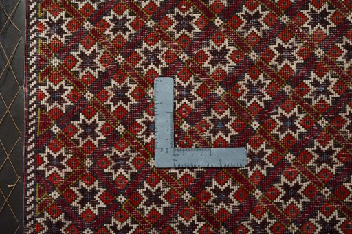 Backside of handmade 2000s Shiraz rug showing knot structure and weave density