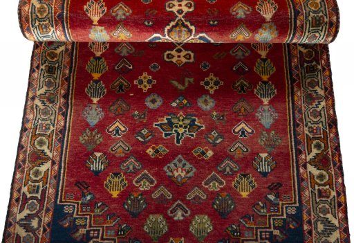 Corner detail of 2000s Shiraz rug showing border pattern and Wool pile