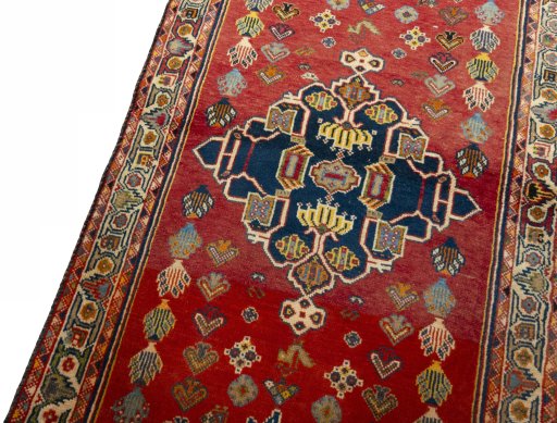 Backside of handmade 2000s Shiraz rug showing knot structure and weave density