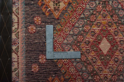 Backside of handmade 2000s Shiraz rug showing knot structure and weave density