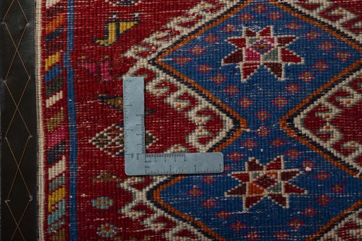 Backside of handmade 2000s Shiraz rug showing knot structure and weave density