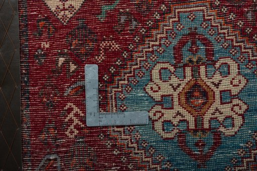 Backside of handmade 2000s Shiraz rug showing knot structure and weave density