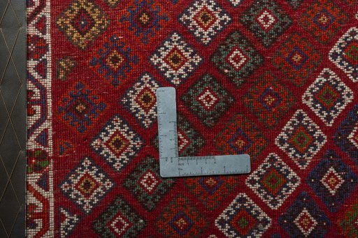 Backside of handmade 2000s Shiraz rug showing knot structure and weave density