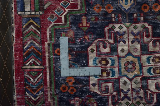 Backside of handmade 2000s Shiraz rug showing knot structure and weave density