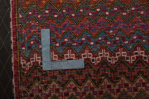 Backside of handmade 1970s Shiraz rug showing knot structure and weave density