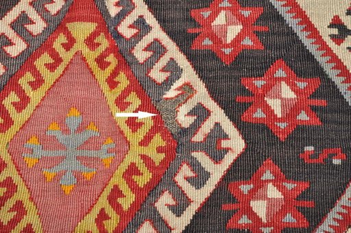 Backside of handmade 1950s Sirjan rug showing knot structure and weave density